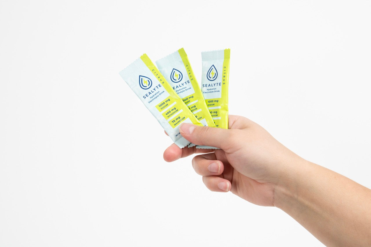 Hand holding three Sealyte packets